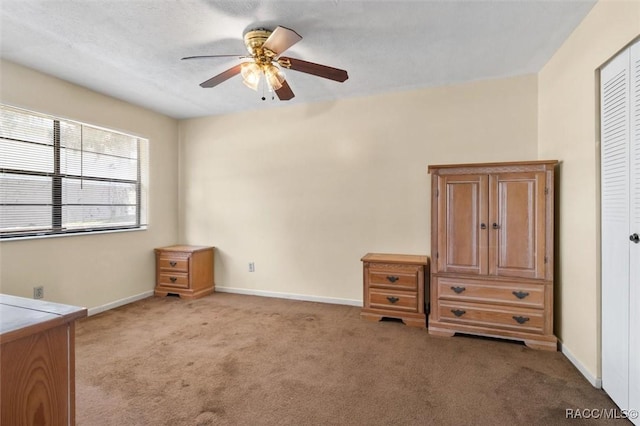 unfurnished bedroom featuring ceiling fan, a closet, and light colored carpet