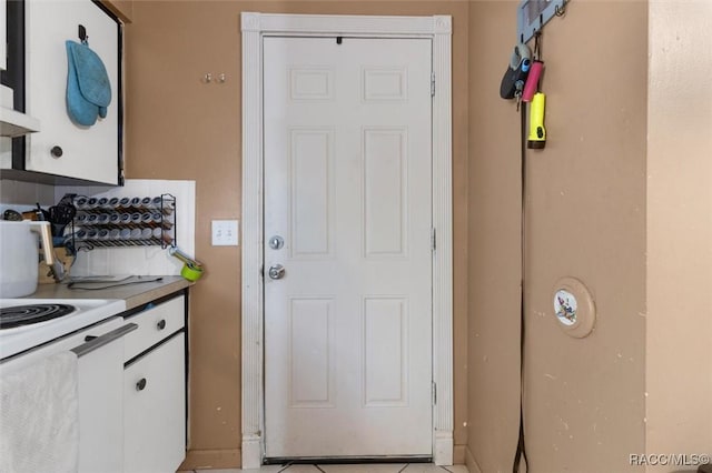 kitchen featuring white cabinets and electric stove