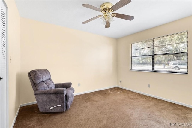 sitting room featuring carpet and ceiling fan