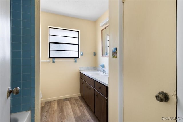 full bathroom featuring shower / tub combination, vanity, wood-type flooring, and toilet