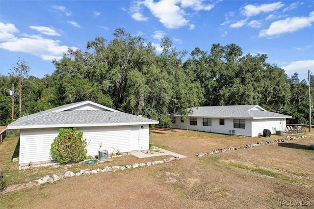 exterior space with a yard and central AC