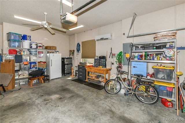 garage with an AC wall unit, ceiling fan, a garage door opener, and white refrigerator