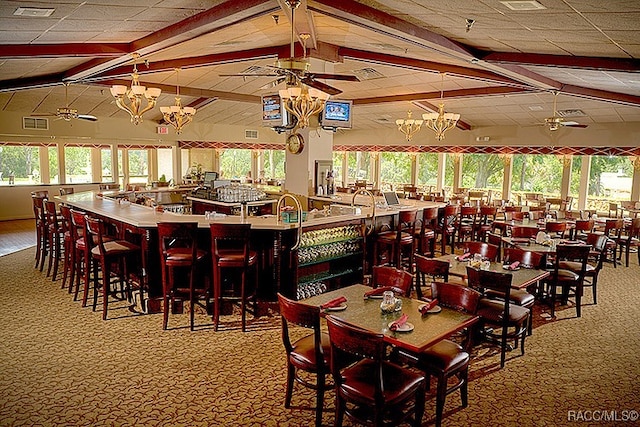 carpeted dining room featuring vaulted ceiling with beams and a notable chandelier