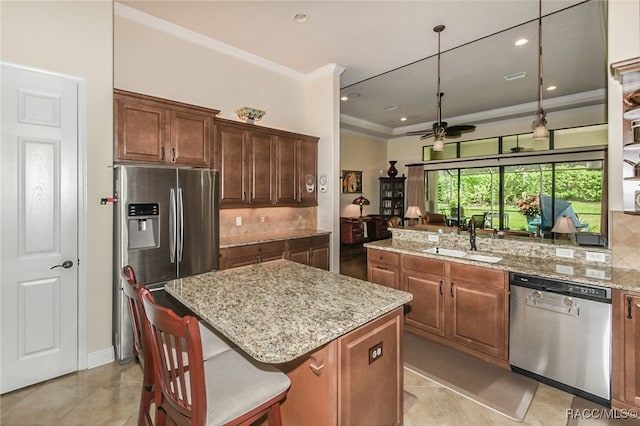 kitchen featuring tasteful backsplash, sink, a center island, and appliances with stainless steel finishes