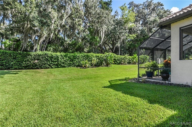 view of yard featuring glass enclosure