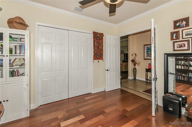 interior space with dark hardwood / wood-style floors, ceiling fan, ornamental molding, and a closet