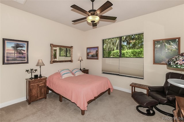 bedroom with ceiling fan and light colored carpet