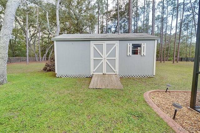 view of shed with fence