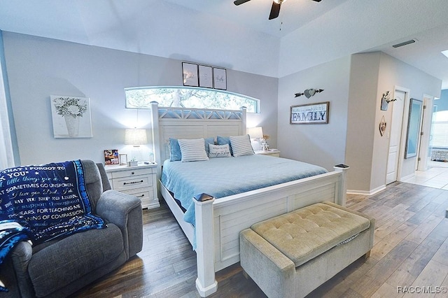 bedroom featuring baseboards, wood finished floors, visible vents, and a ceiling fan