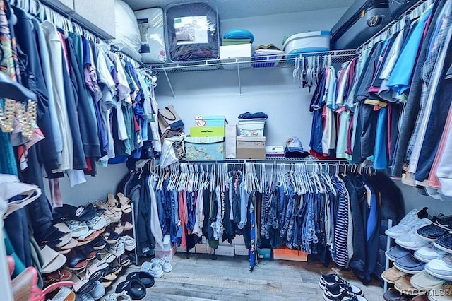 spacious closet with wood finished floors