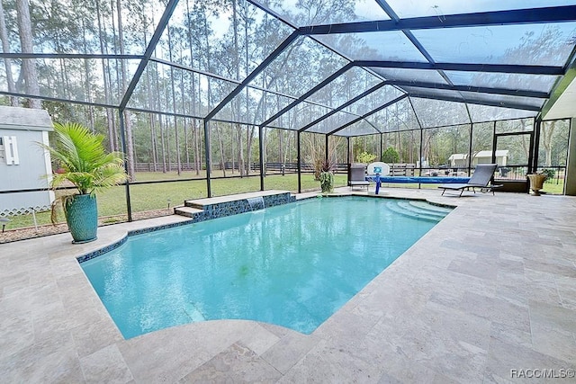 pool with a patio, a yard, and glass enclosure