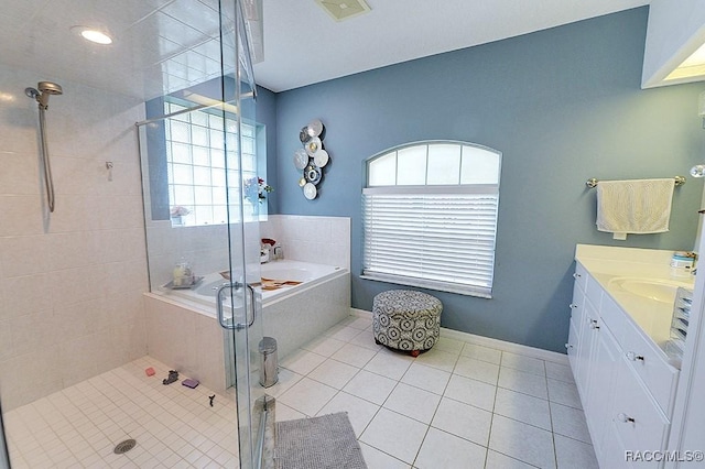 bathroom with a garden tub, tile patterned flooring, vanity, baseboards, and a shower stall