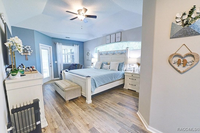 bedroom featuring light wood-style floors, a ceiling fan, a textured ceiling, access to outside, and baseboards