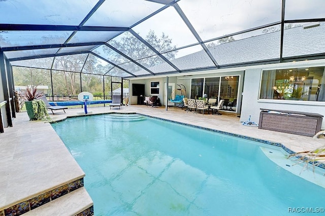 pool with a lanai and a patio