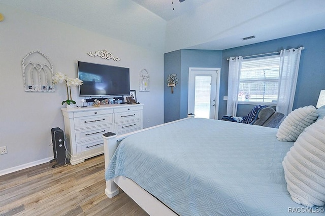 bedroom with visible vents, light wood-style flooring, and baseboards