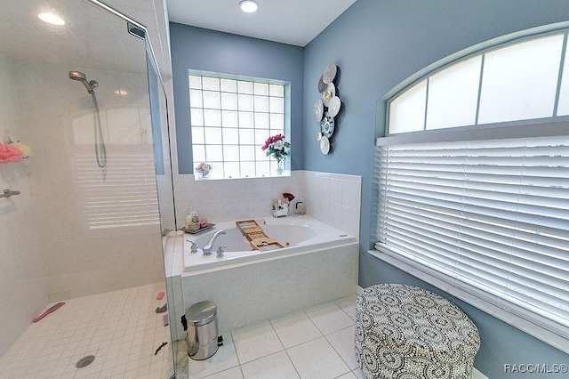 full bathroom featuring a stall shower, a garden tub, and tile patterned floors