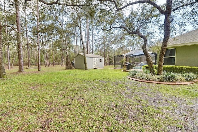 view of yard with an outbuilding, a gazebo, a shed, and fence