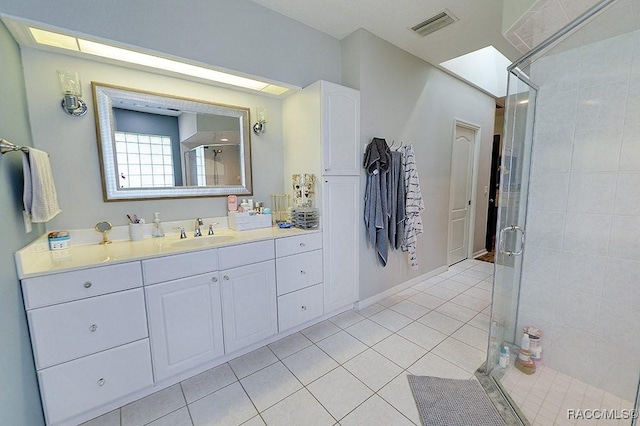 bathroom with vanity, tile patterned flooring, a shower stall, and visible vents