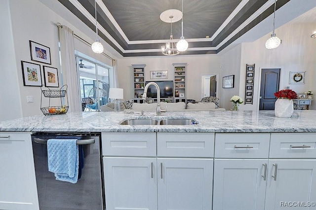 kitchen featuring a raised ceiling, dishwasher, open floor plan, white cabinetry, and a sink