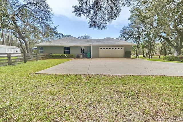 ranch-style house featuring stucco siding, an attached garage, a front yard, fence, and driveway