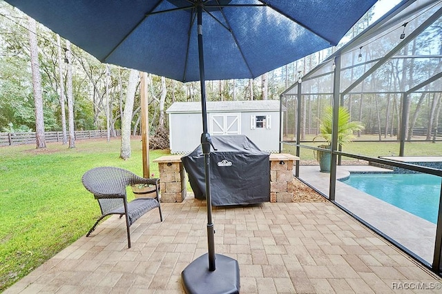 view of patio featuring an outbuilding, a shed, a lanai, and fence