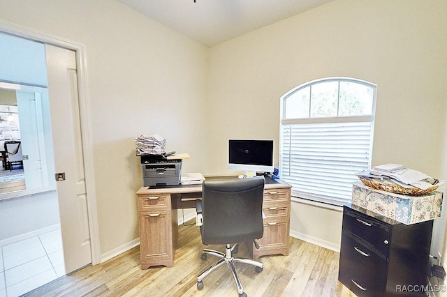 office with light wood-type flooring and baseboards