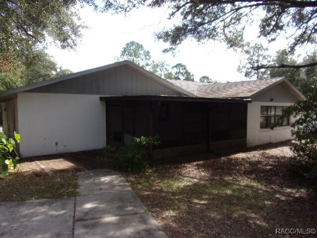 view of property exterior with a sunroom