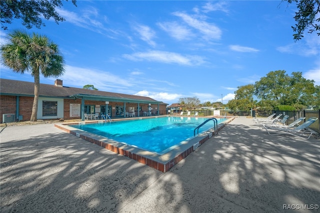 view of swimming pool with a patio