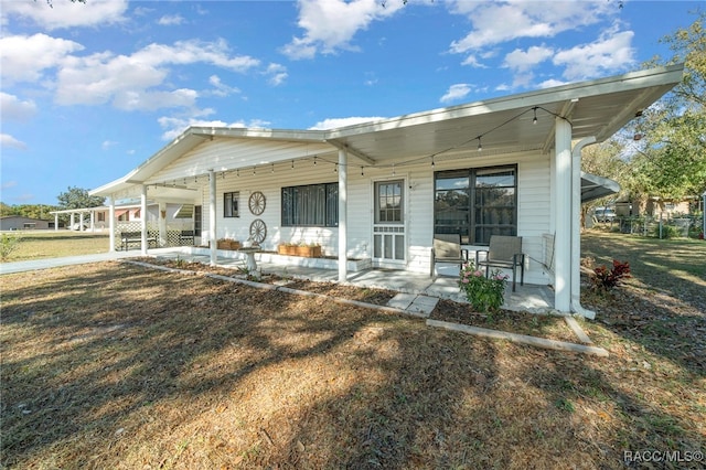 back of house featuring a porch