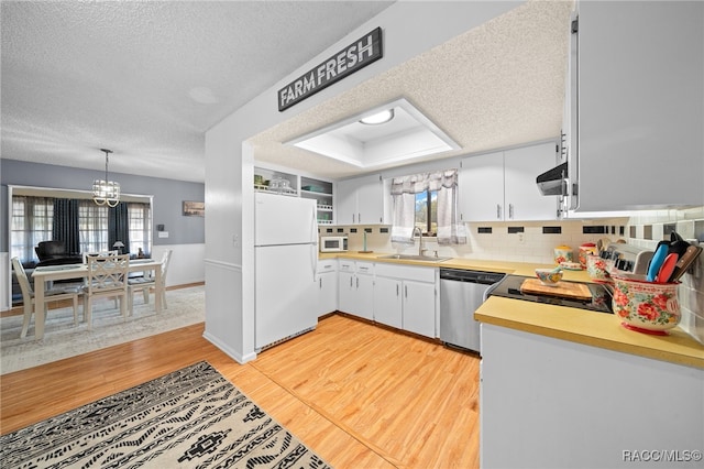 kitchen featuring a healthy amount of sunlight, stainless steel appliances, light hardwood / wood-style floors, and sink