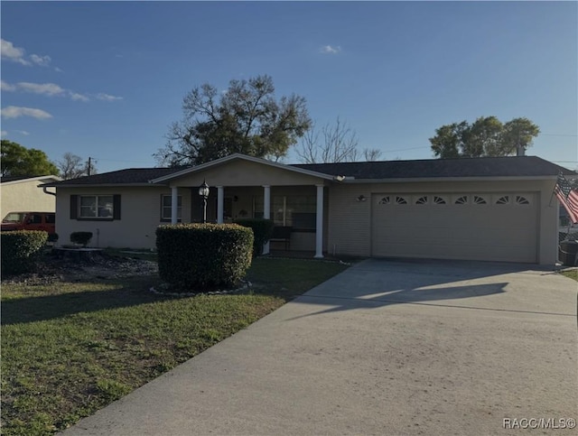 ranch-style house featuring an attached garage, driveway, and a front lawn