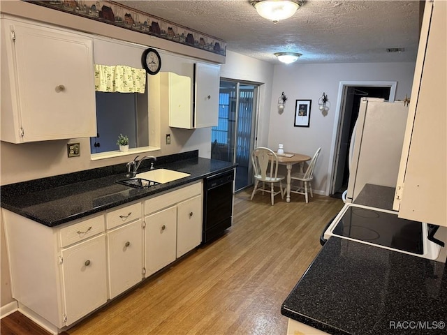 kitchen featuring white cabinetry, a sink, and dishwasher