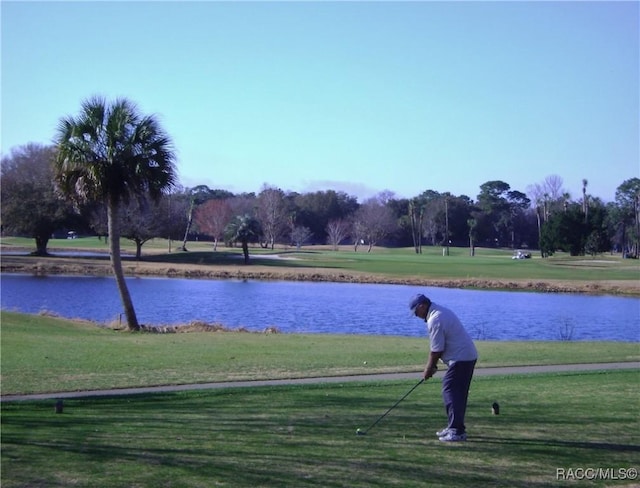 surrounding community with a lawn and a water view