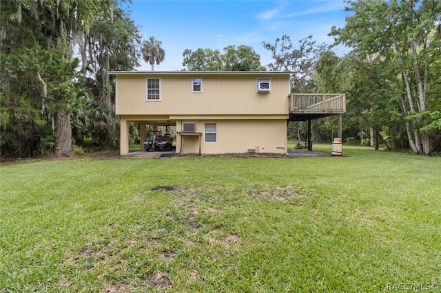 back of house with a wooden deck and a yard