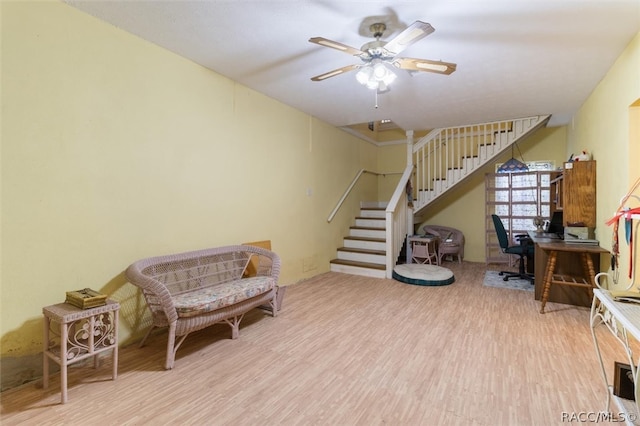 living area with ceiling fan and light hardwood / wood-style floors