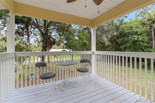 wooden deck featuring ceiling fan