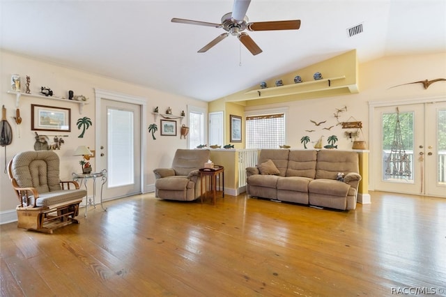 living room with ceiling fan, light hardwood / wood-style floors, lofted ceiling, and french doors