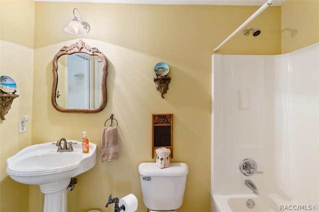 bathroom featuring shower / bath combination and toilet