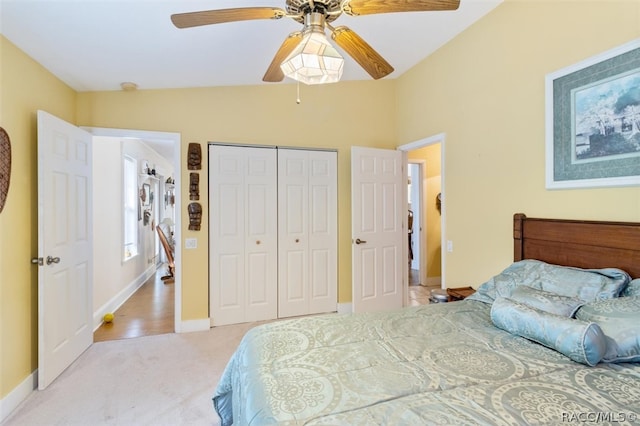 carpeted bedroom featuring a closet, ceiling fan, and lofted ceiling