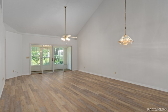 empty room with hardwood / wood-style flooring, high vaulted ceiling, and ceiling fan