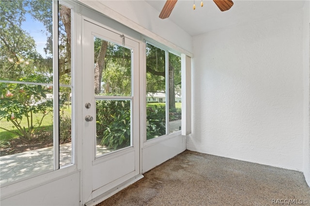 entryway with ceiling fan and carpet floors