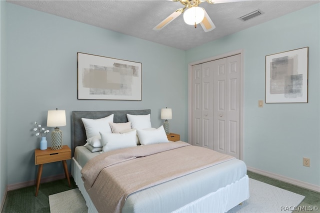 bedroom featuring ceiling fan, a closet, carpet floors, and a textured ceiling