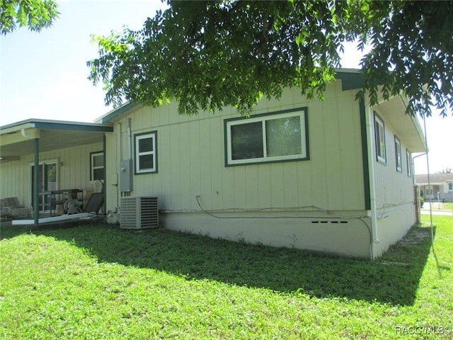 rear view of house with crawl space, a lawn, and central air condition unit