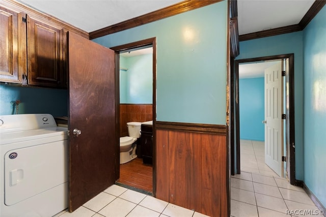 laundry room with cabinets, washer / dryer, light tile patterned floors, and ornamental molding