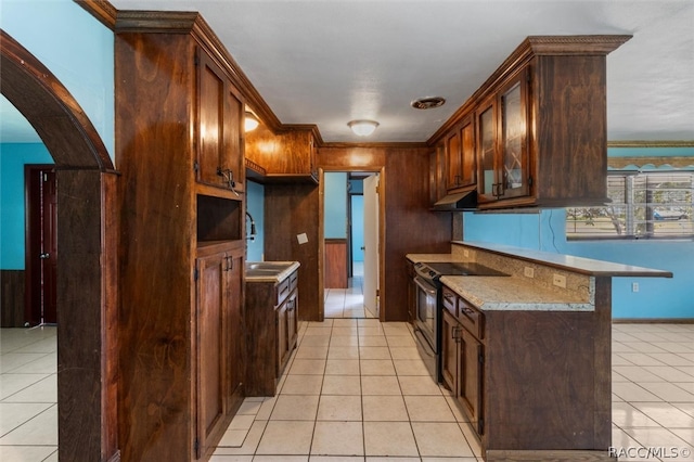 kitchen with a kitchen breakfast bar, crown molding, stainless steel range with electric cooktop, and light tile patterned flooring