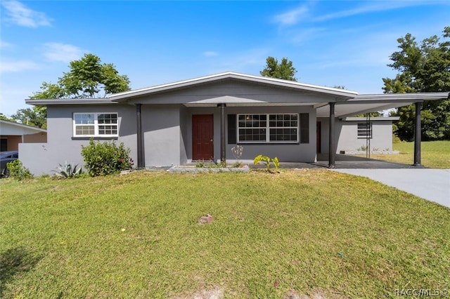 ranch-style home featuring a carport and a front yard