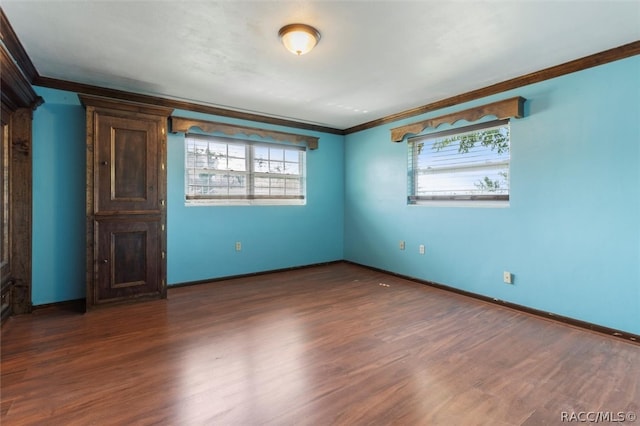 spare room with dark hardwood / wood-style floors and ornamental molding