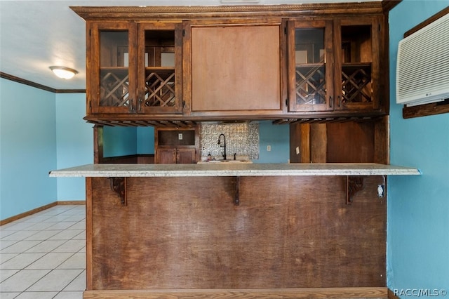 bar featuring light tile patterned floors, a wall unit AC, ornamental molding, and sink