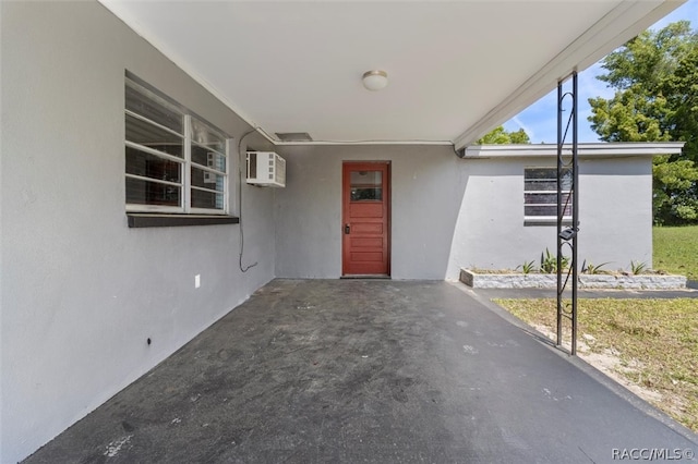 view of exterior entry featuring a wall mounted AC