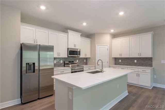 kitchen featuring white cabinetry, sink, stainless steel appliances, and wood-type flooring